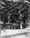 1921-1922 Packard two-toned runabout parked on tree-lined drive