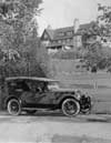 1922-1923 Packard touring car, mansion in background