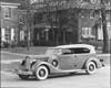 1935 Packard phaeton, three-quarter left side view, top raised, parked on street