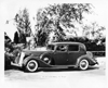 1936 Packard club sedan, parked on drive, gateway in left background