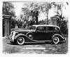 1936 Packard limousine, parked in front of gated driveway