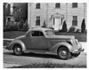 1936 Packard business coupe, parked on street in front of house