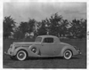 1936 Packard coupe, nine-tenths left side view, parked on grass