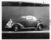 1937 Packard convertible coupe, top raised, rumble seat open