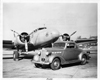 1937 Packard business coupe, parked on air strip in front of Boeing airplane