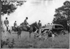 1937 Packard touring sedan, surrounded by men and dogs on a fox hunt