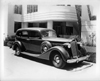 1937 Packard touring sedan in front of contemporary home