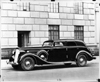 1937 Packard special sport sedan, nine-tenths left side view, parked on street