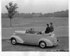 1937 Packard convertible sedan, couple sitting on folded top at Belle Isle