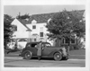 1937 Packard touring sedan parked on street in front of house