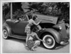 1937 Packard convertible victoria examined by bathing beauties