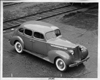 1938 Packard touring sedan parked near railroad tracks