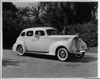 1939 Packard touring sedan, two female passengers, man standing by driver