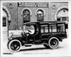 1914 Packard truck, left side view, parked on street in front of W.S. Seaman Company building