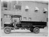 1915 Packard truck of Great Falls Meat Co. parked on street next to building