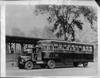 1922 Packard truck with City of Detroit bus trailer, two men in front cab, passengers in back