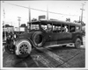 1915-16 Packard jitney bus, parked on street, man behind wheel, two male passengers