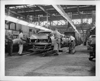 1956 Packard metal bodies on assembly line, entering spraying tunnel