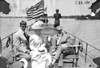 Two men and a woman sitting on bench at the bow of a boat, at 1909 Glidden Tour