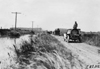 Participants passing by quicksand near Duncan, Neb., at the 1909 Glidden Tour