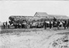 Covered Glidden tourist vehicles in front of Pullman car in Kearney, Neb., at 1909 Glidden Tour