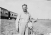 Glidden tourist stands near Pullman car in Kearney, Neb., at 1909 Glidden Tour