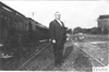 Dai Lewis standing near Pullman car in Kearney, Neb., at 1909 Glidden Tour
