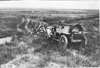 Group photo of Glidden tourists posed in front of vehicle on the Colorado prairie, at 1909 Glidden Tour