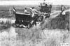Glidden tourist vehicle pulled from the mud by a team of horses, on Colorado prairie, at 1909 Glidden Tour