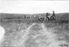 Participants passing through a farm yard, at the 1909 Glidden Tour