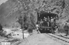 Glidden tourists standing on the back of a train in Clear Creek Canyon, Colo., at 1909 Glidden Tour