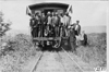 Glidden tourists standing on the back of a train headed for Mt. McClellan, Colo., at 1909 Glidden Tour