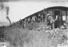 Glidden tourists look out from railroad cars headed for Mt. McClellan, Colo., at 1909 Glidden Tour