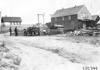 Rapid motor truck on rural road near house in Colo., at 1909 Glidden Tour