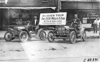 Two Brush runabout cars with drivers posed in front of building in Kansas City, Mo., at 1909 Glidden Tour