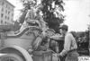 Glidden tourists fasten rope to the back of car, at 1909 Glidden Tour