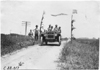 Smithson in Studebaker car on rural road, at 1909 Glidden Tour