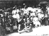Glidden tourists pose with women and children, in Wilton (Minn.?), at 1909 Glidden Tour
