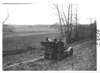 E.M.F. car on rural road overlooking farm land, on pathfinder tour for 1909 Glidden Tour