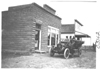 E.M.F. car parked in front of a bank, on pathfinder tour for 1909 Glidden Tour