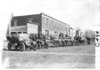 E.M.F. car along side other cars parked in front of commercial buildings, on pathfinder tour for 1909 Glidden Tour