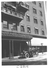 E.M.F. car parked in front of a building, on pathfinder tour for 1909 Glidden Tour