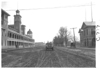 E.M.F. car passing building with belfry, on pathfinder tour for 1909 Glidden Tour
