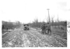 E.M.F. car being pulled from mud, on pathfinder tour for 1909 Glidden Tour