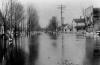 Flood, looking down River Street with boat, Lansing, 1904