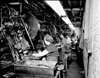 Employees stamping out parts for air rifles at the Daisy Manufacturing Company