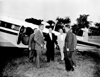 Governor G. Mennen Williams standing in front of an airplane at Mettetal Airport