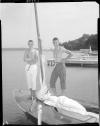Two boys modeling pants on a boat