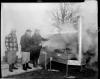 Grand opening Allegan bank - men cooking outside