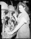 Woman working a drill press